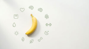A yellow banana sits on a white background surrounded by health-related icons in green.