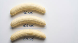 Three bananas on a white background, labeled with calorie counts: 90 cal, 105 cal, and 121 cal.