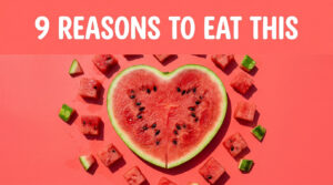 A heart-shaped watermelon slice surrounded by smaller watermelon cubes on a pink background.